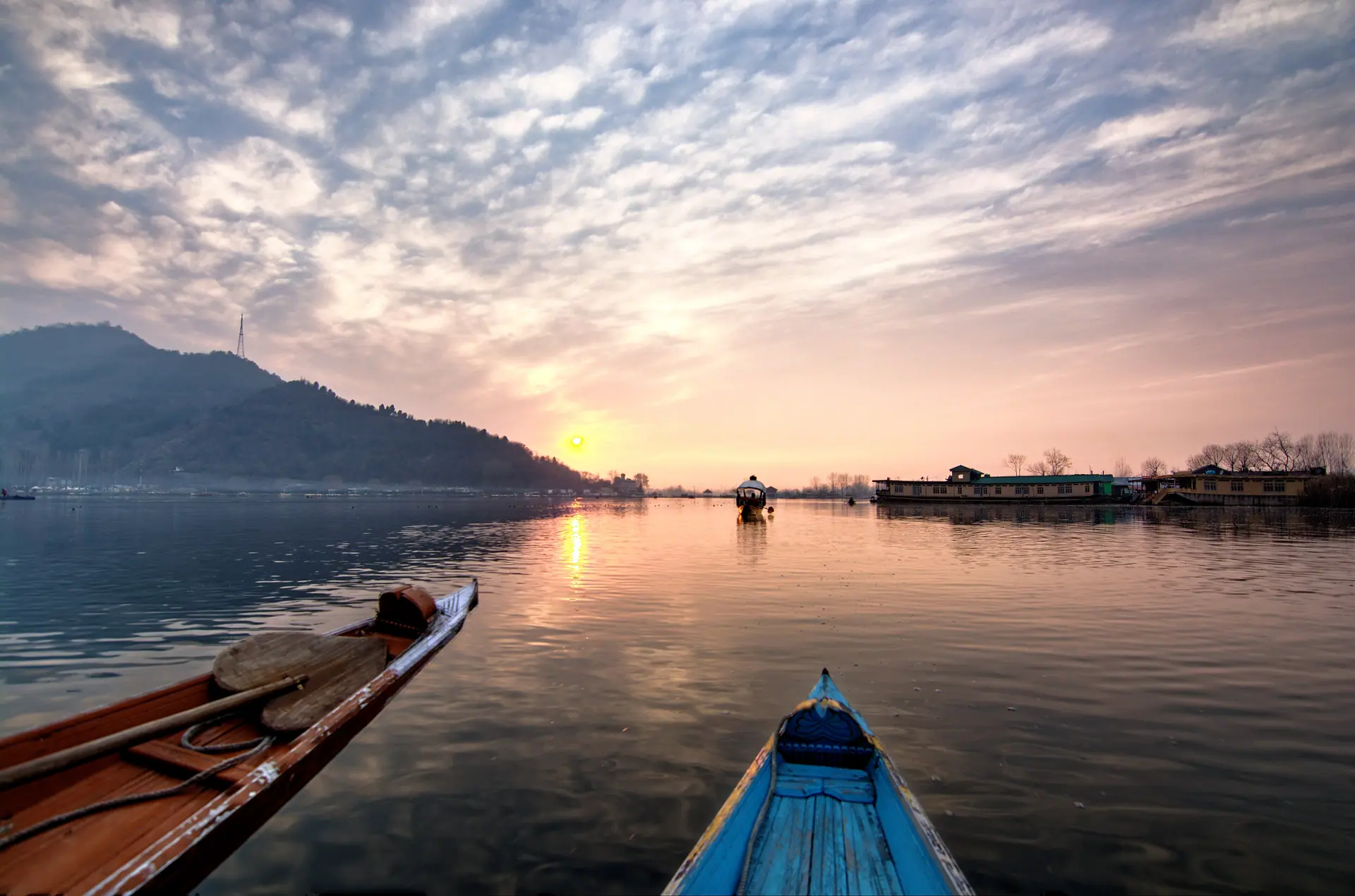Dal Lake at sunset with shikaras resting on calm water in Srinagar