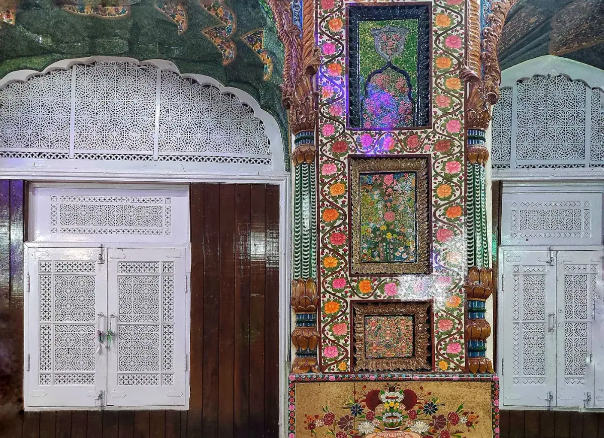 Painted papier-mâché and carved lattice work inside a shrine in Srinagar