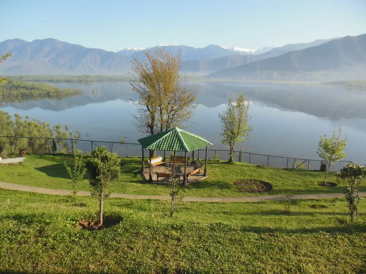 Wular Lake in calm morning light with mountains reflected in the water
